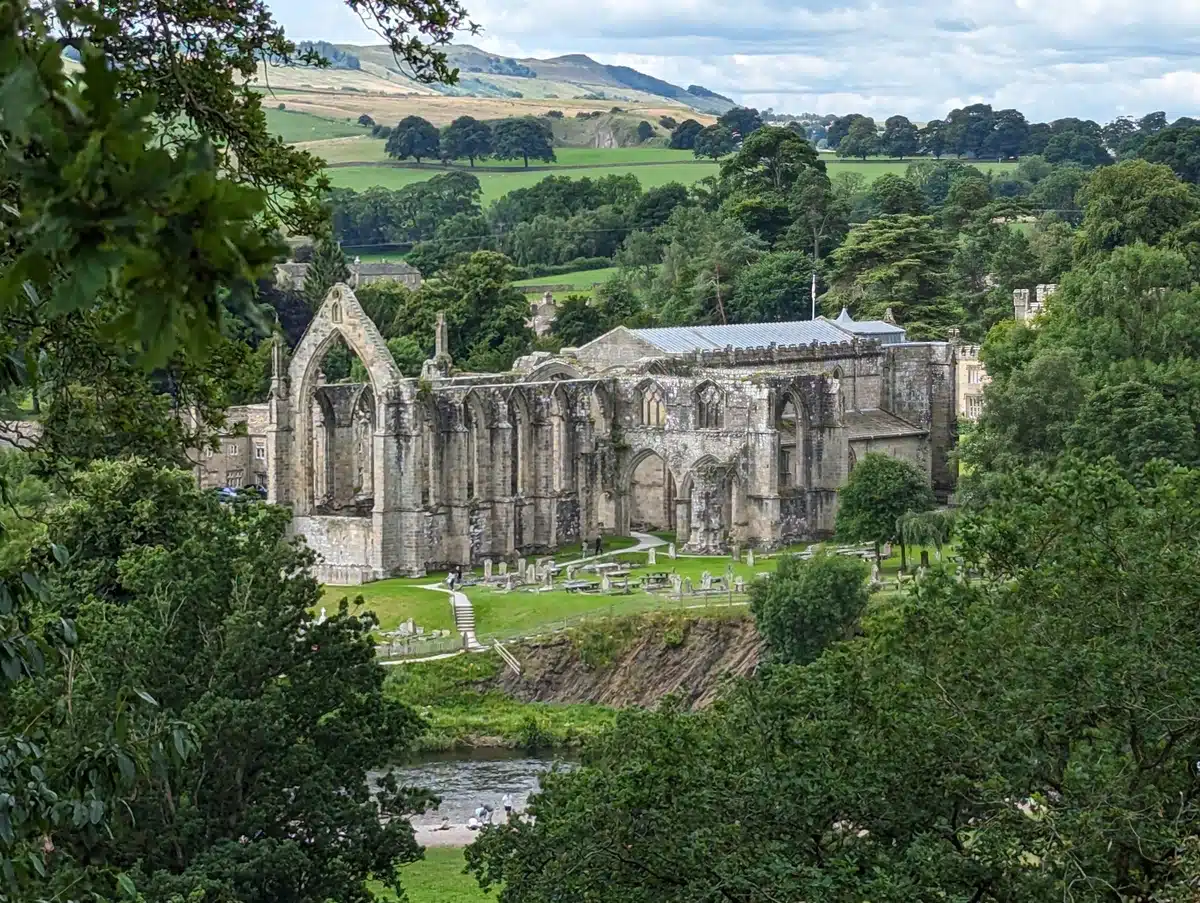 A shot of Bolton Abbey through the trees from the Welly Walk. A Family Guide to Bolton Abbey and Beyond