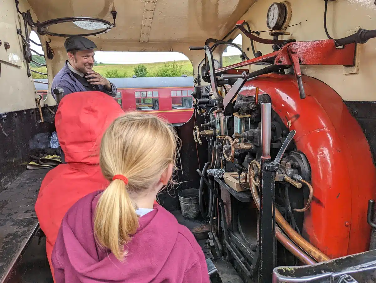 Young children in the cab of a steam train at Embsay & Bolton Abbey Steam Railway 
