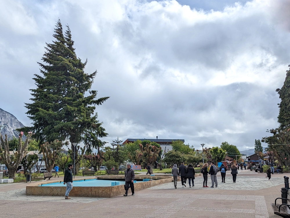 People enjoying Plaza de Armas in the centre of Coyhaique.