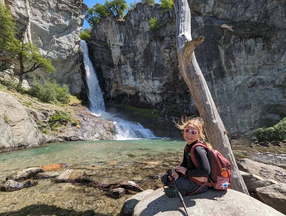 Eva sat on a rock by Chorillo del Salto waterfall. A child friendly walk from El Chalten