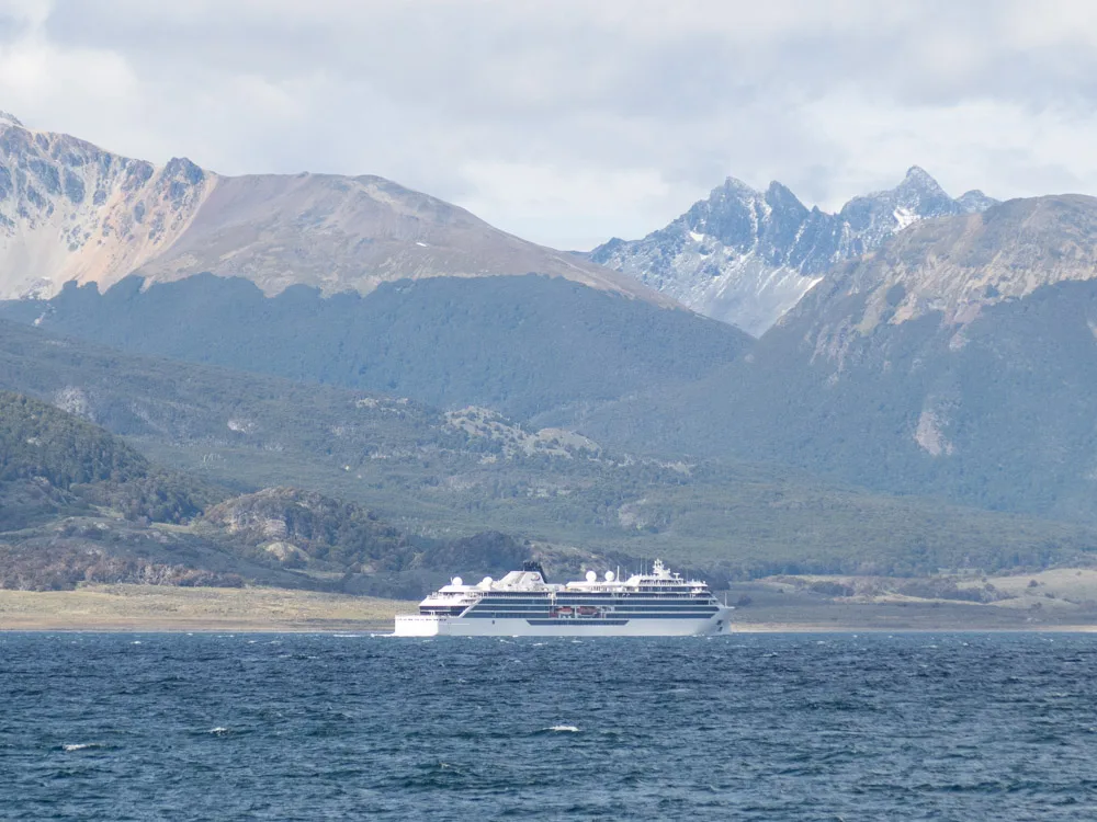 A large cruise ship on the Beagle Channel in Ushuaia with mountains in the background