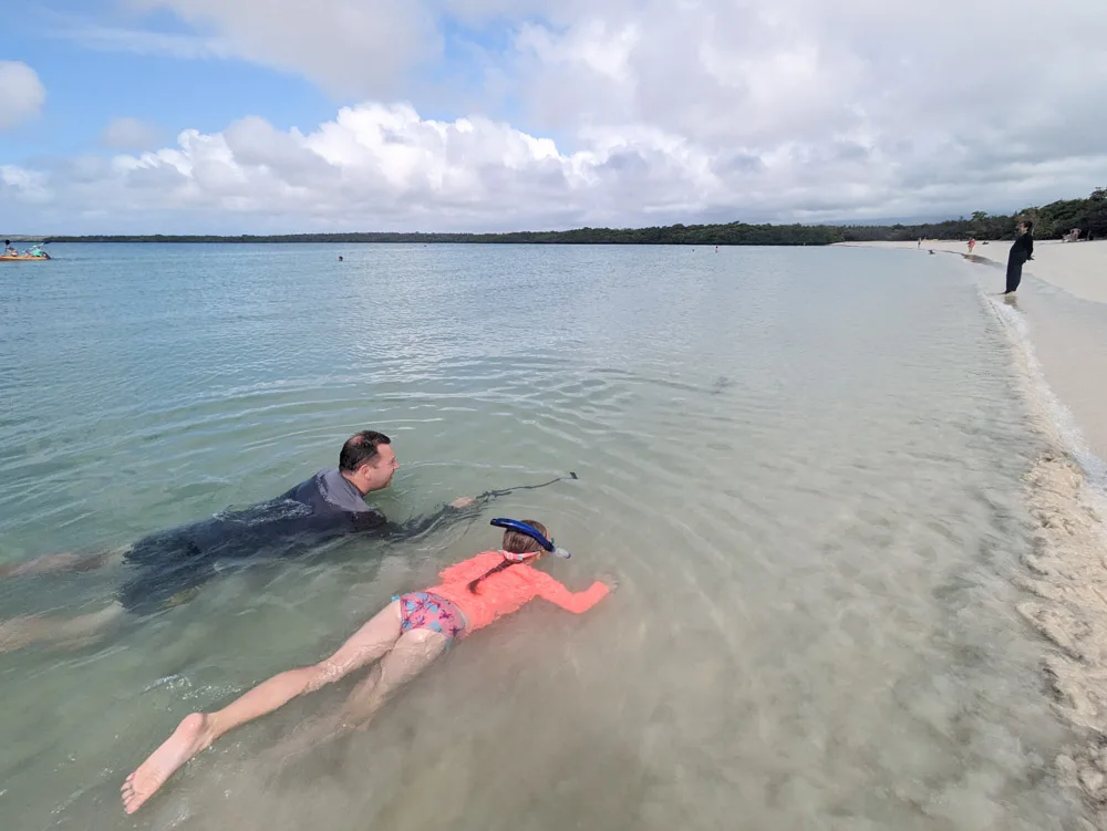 Adrian and Eva swimming in Tortuga Bay complete with rashies. All part of the essential packing list for visiting the Galapagos Islands with kids.