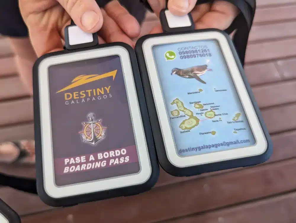 A close up of both sides of the boarding pass to board the ferry between Santa Cruz and Isla Isabella. Showing the name of the boat and a map of the Galapagos islands.
